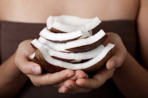 Resized_Woman_Holding_Coconut_Slices_81669139